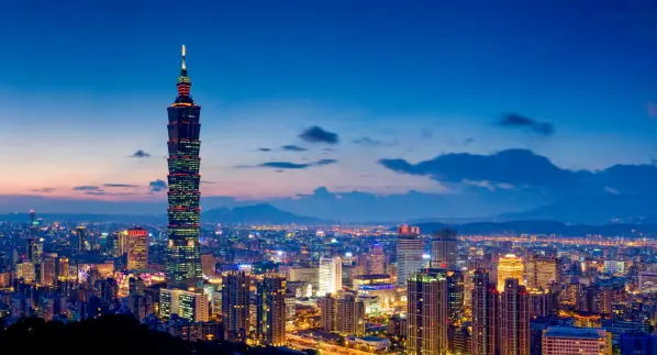 How to Learn Mandarin Fast: Essential Tips for Rapid Mastery in Taiwan 2 The Taipei 101 skyscraper towers over the cityscape of Taipei at dusk, illustrating a vibrant setting for those exploring how to learn Mandarin fast.