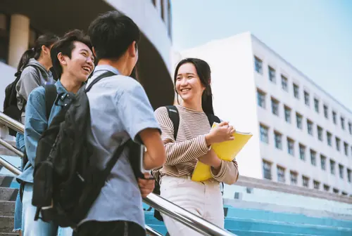 Happy Students Talking and Walking on Stairs