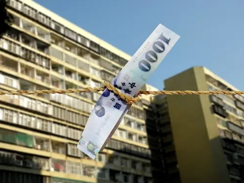 Banknotes Tied to String on House Background 