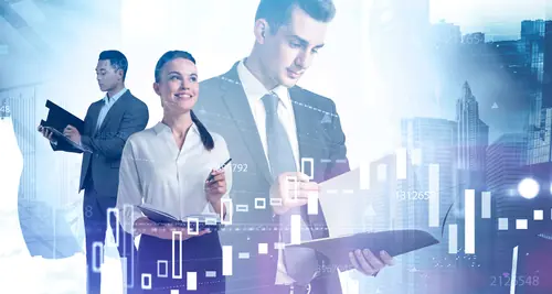 10 Jobs in Business Administration 2 Young Business People Working Together with Exposure to Financial Charts