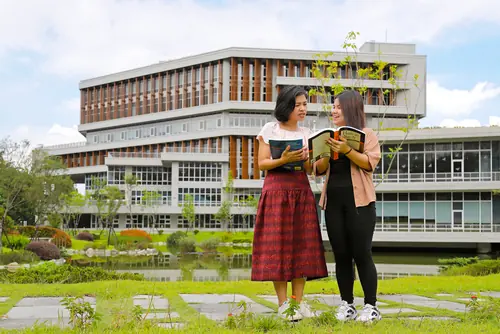 Master’s program students discussing outside of a campus in Taiwan.